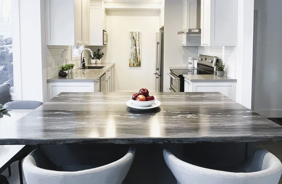  Kitchen with white cabinets, island with laminate countertop and fruit bowl