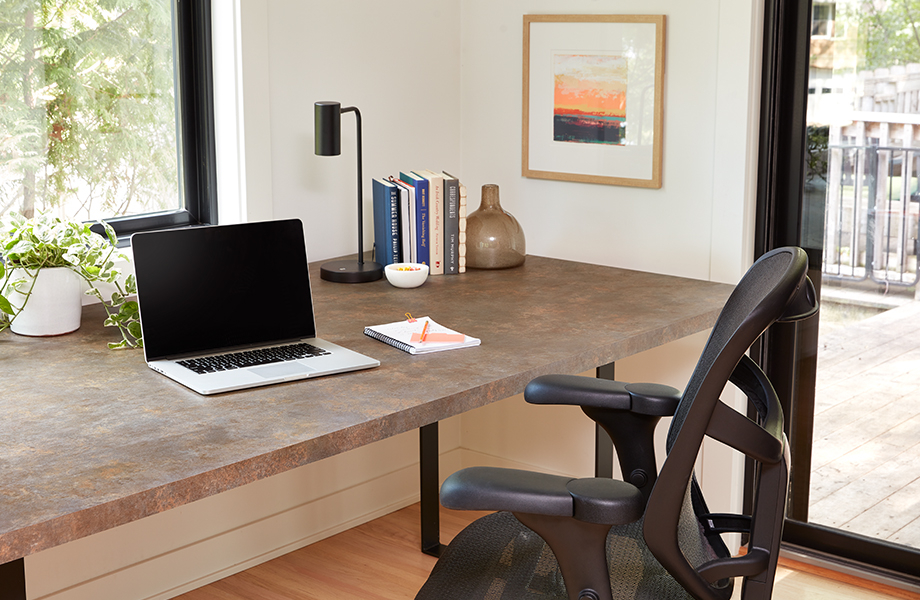 Light and bright home office with Patine Bronze Formica Laminate desk, office chair and desk accessories
