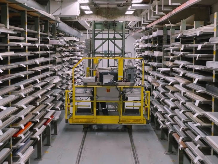 Shelves on both sides with laminate sheets and yellow machine