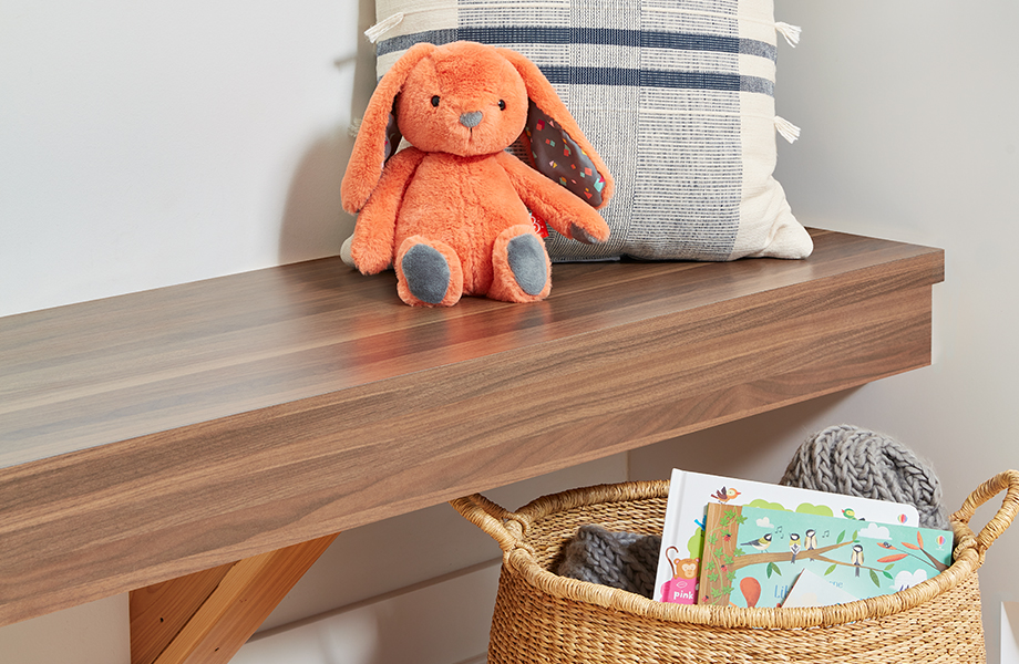 Bench in Walnut Butcherblock Formica Laminate with stuffed animal, pillow and basket of books